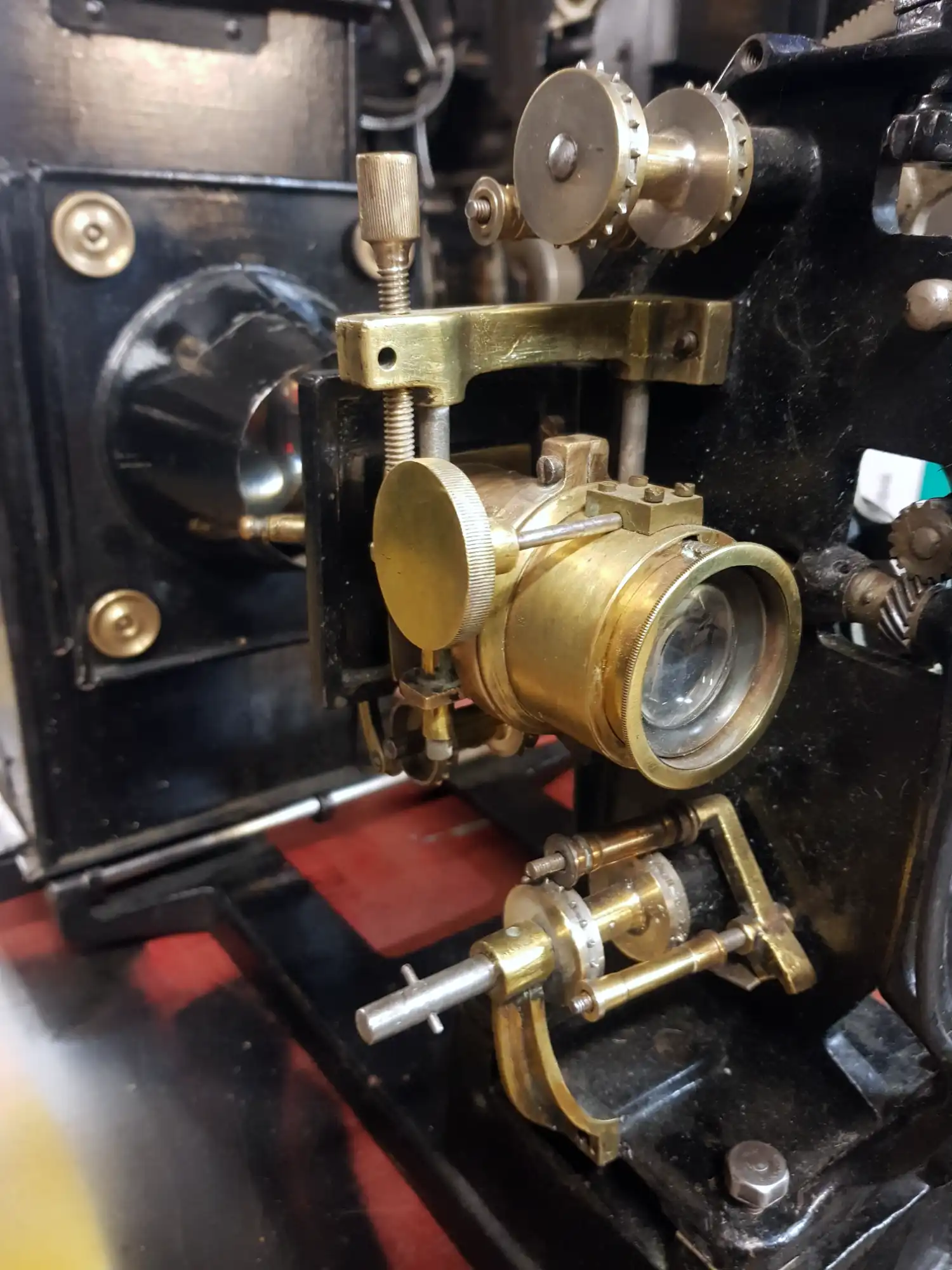 A black projector mechanism with gold lens