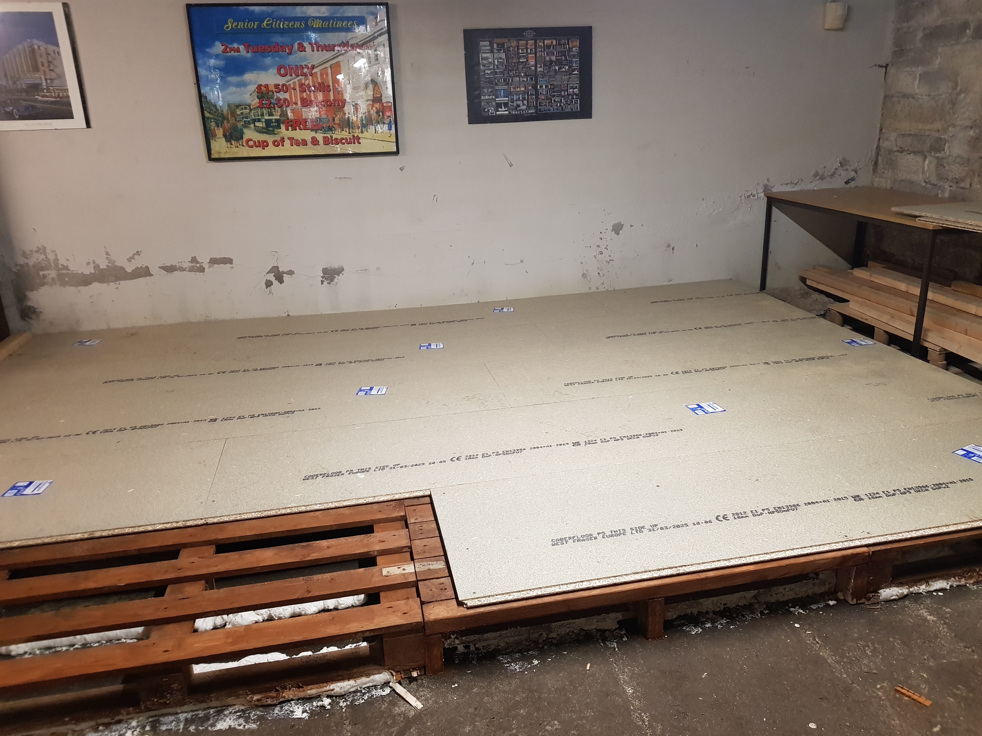 Chipboard panels laid on top of a pallet floor