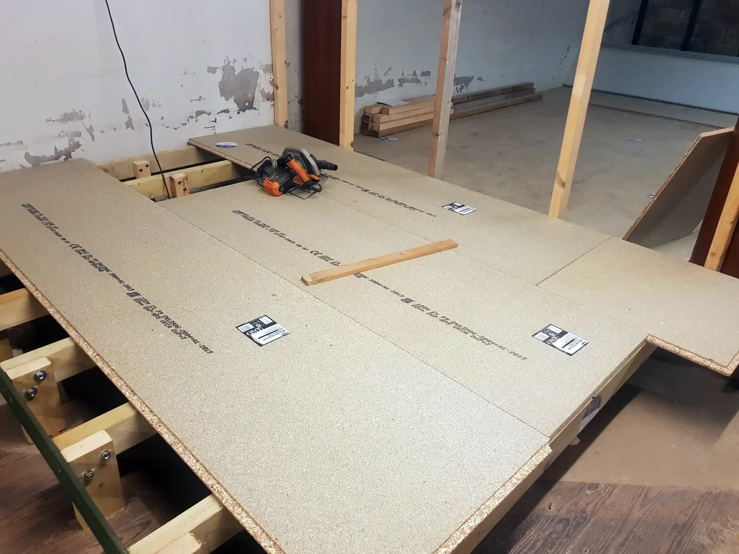 Floor boards lying on top of floor joists.