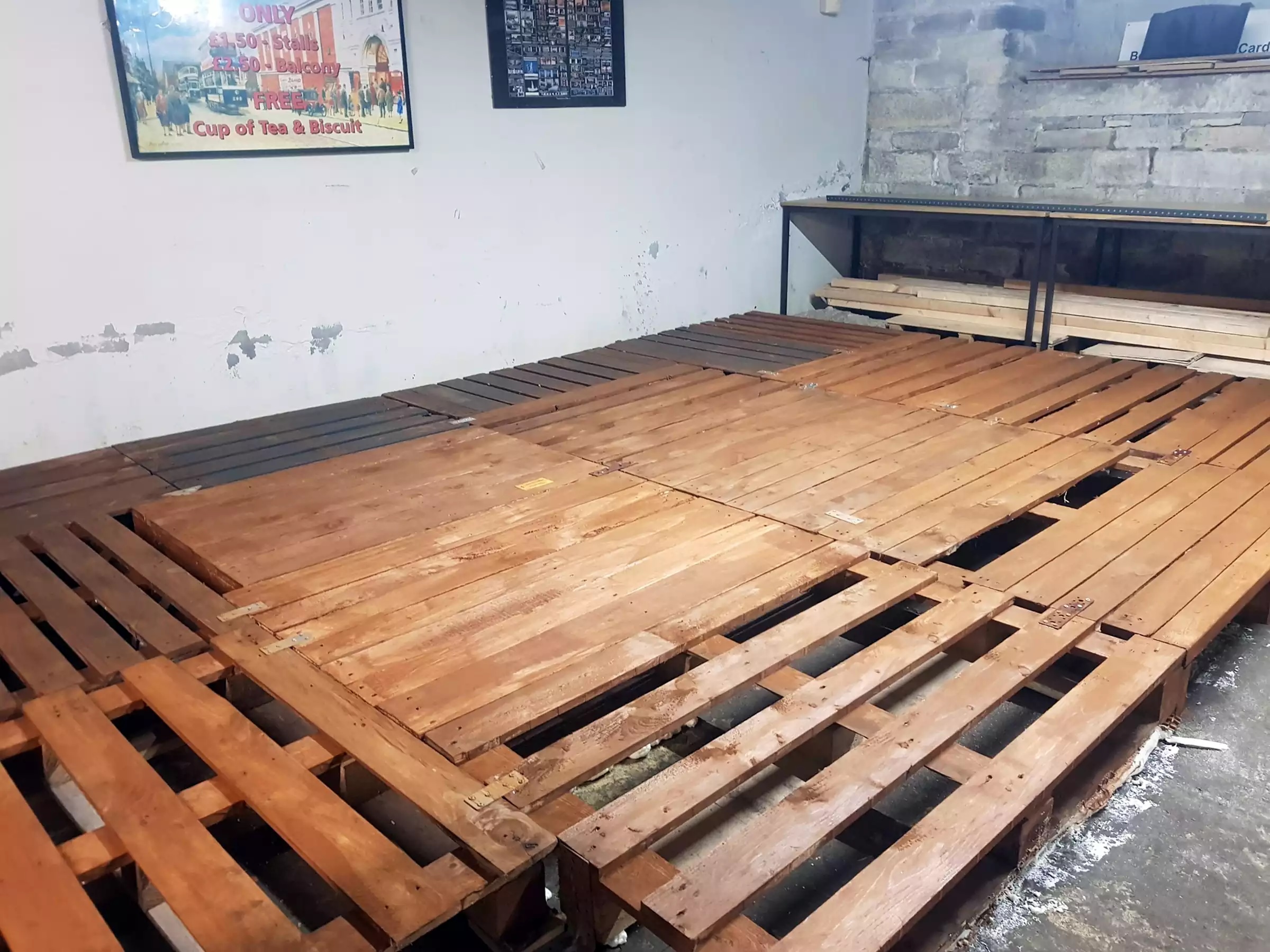 Pallets attached to a floor to form a level surface
