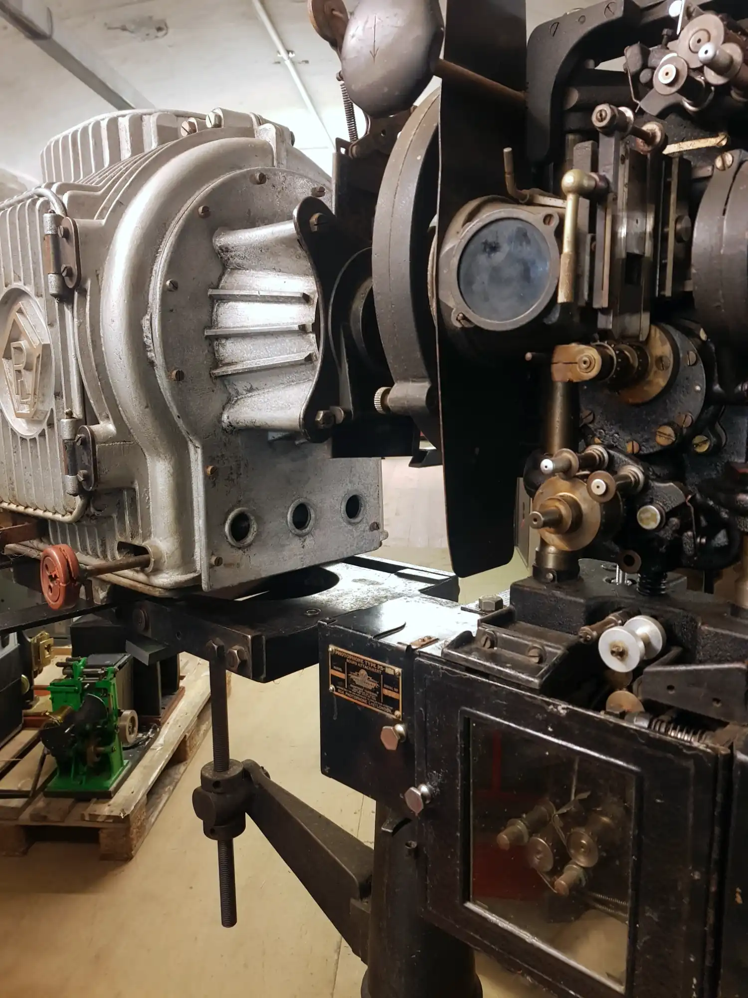 Silver metal box behind a black metal projector mechanism