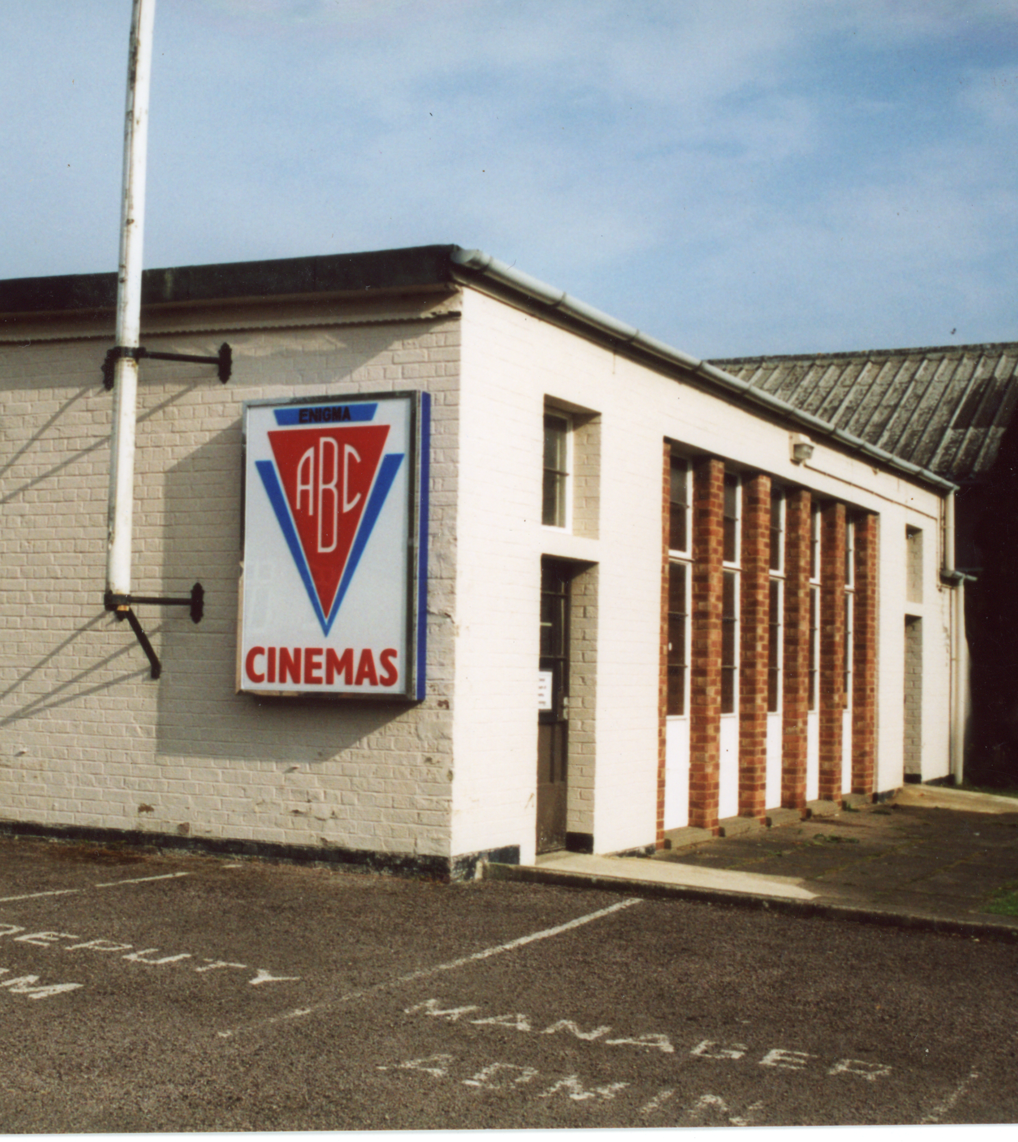 A white single story building with an ABC Cinemas sign on the front